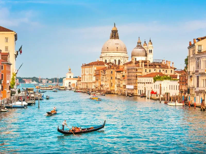 Gondolas on the Grand Canal among historic buildings in Venice, Italy
