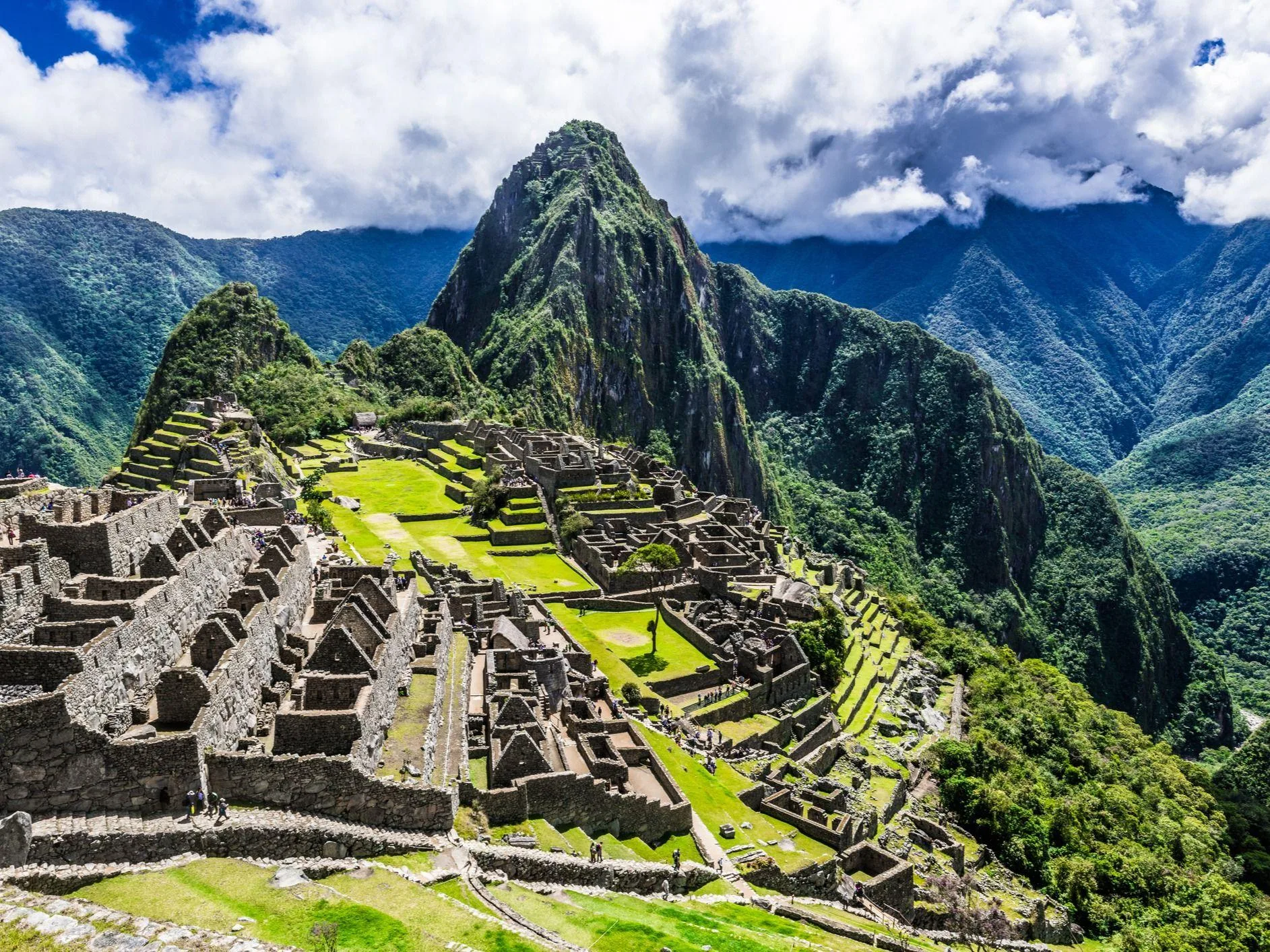 Ancient stone citadel of Machu Picchu surrounded by green Andean mountains in Peru