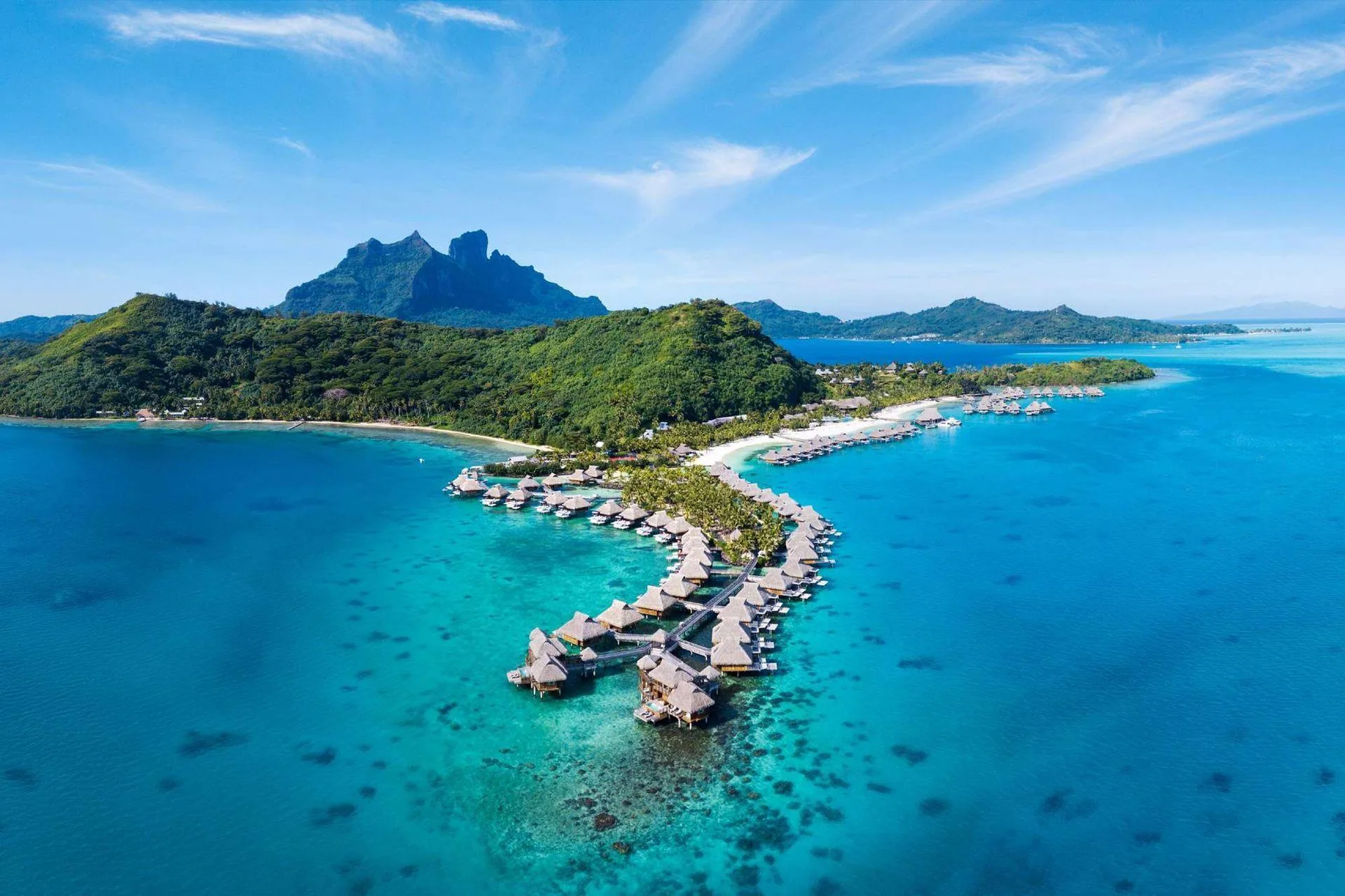 Overwater bungalows above the turquoise lagoon in Bora Bora, French Polynesia